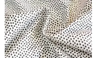 Tissu blanc pois noirs