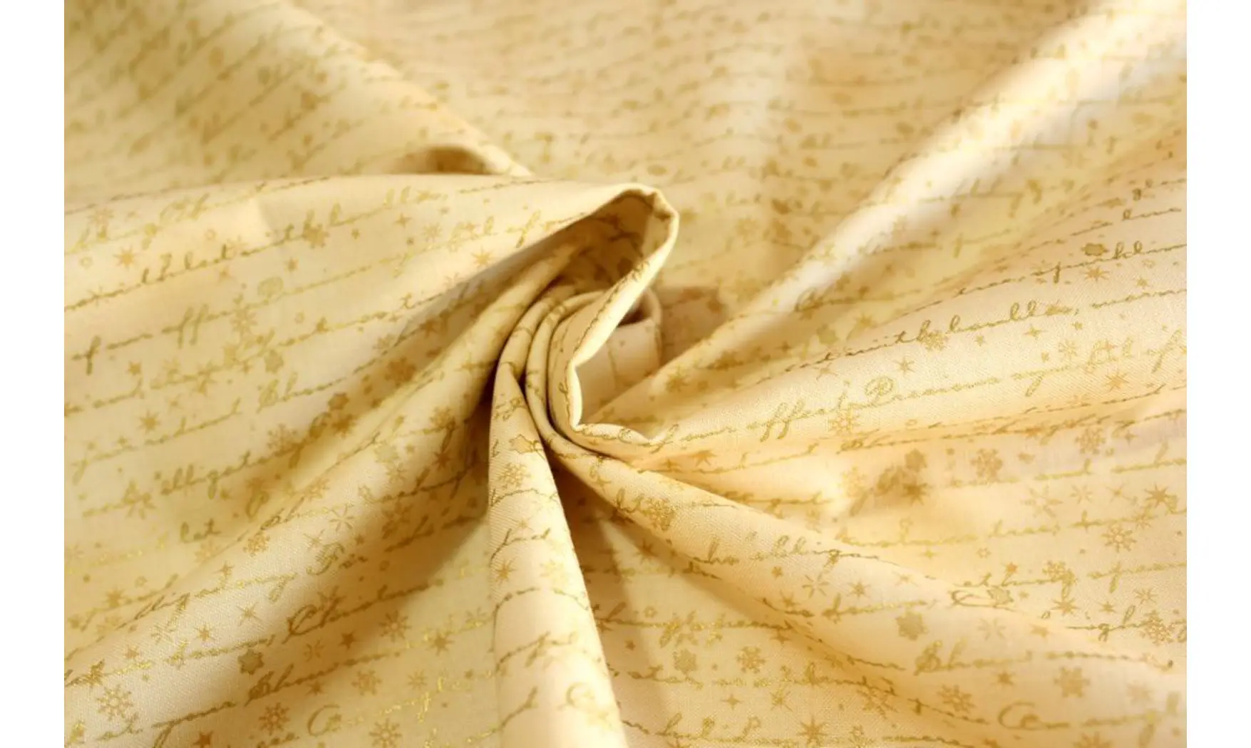 Tissu écritures dorées